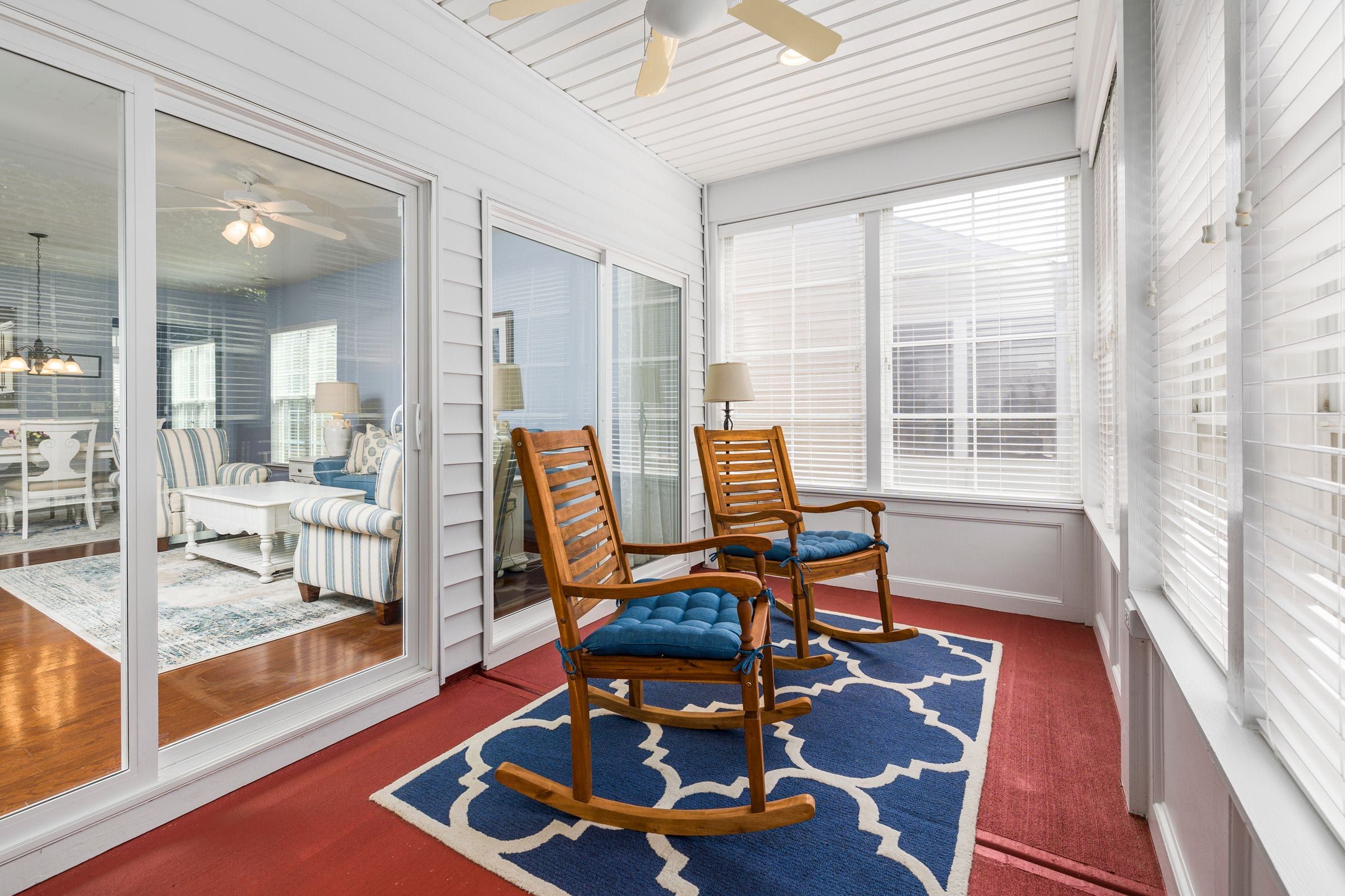 Sunroom addition with sliding glass doors to the living room and windows on three sides