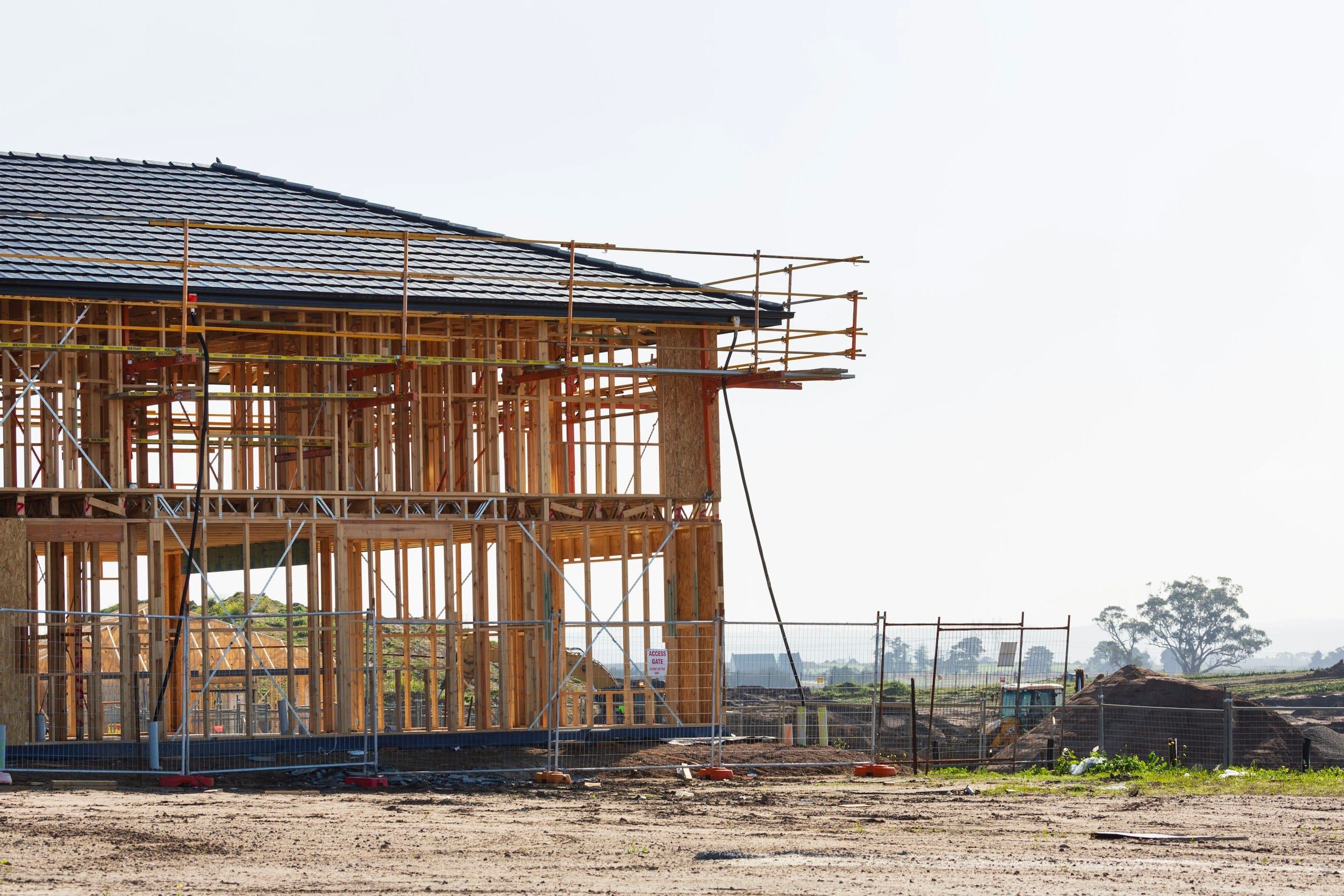 Two-story frame with the roof tiles going on