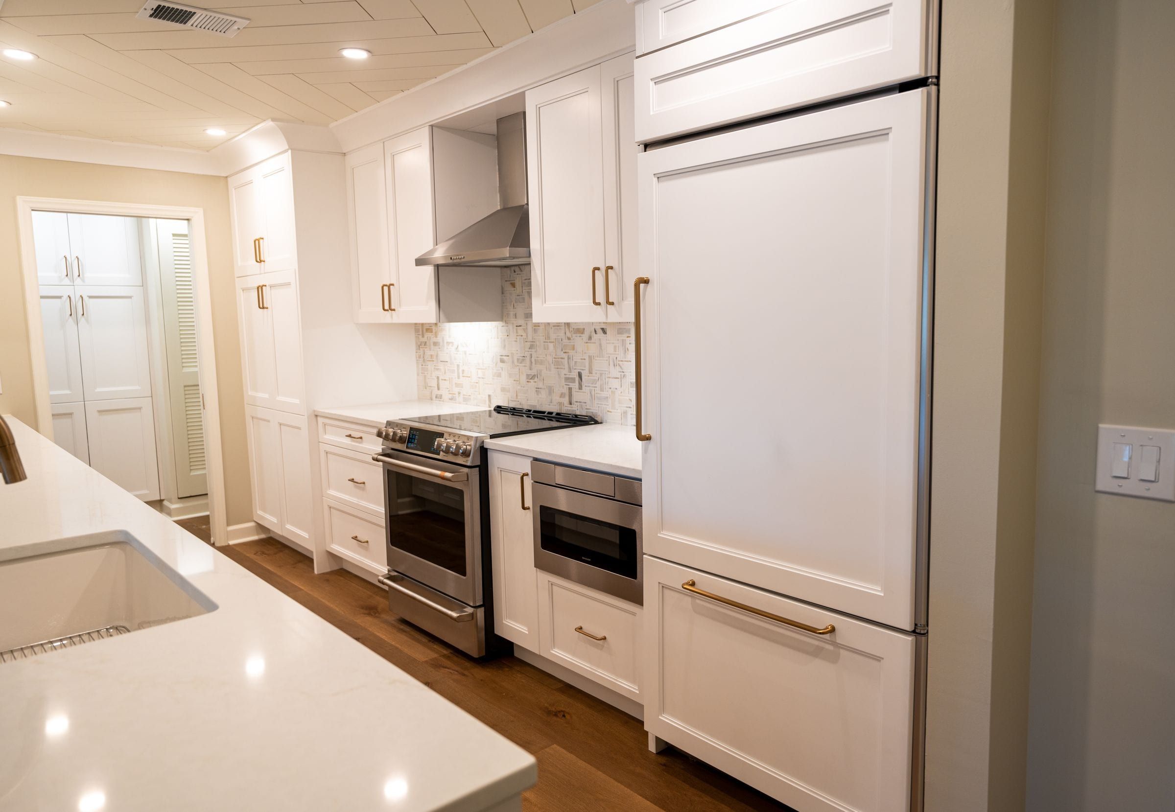 Panel-ready refrigerator and tall pantry cabinets